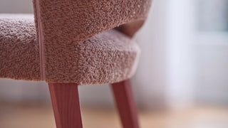 Detail of the pink bouclé back of a Mobitec Cuori chair with pink legs