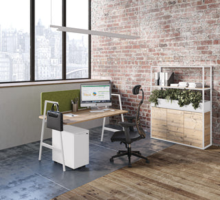 Lifestyle image of a Buronomic Alto bookcase in white and Timber with plants by a desk and brick wall