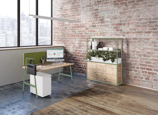 Lifestyle image of a Buronomic Alto bookcase in Timber by an almond green desk in a loft