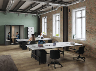 Lifestyle image of Buronomic Paisible pedestals under workstations in a loft with a green wall