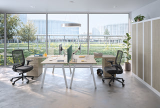 Lifestyle image of Buronomic Comfort desk-height pedestals as return in white and wire oak by a glass facade