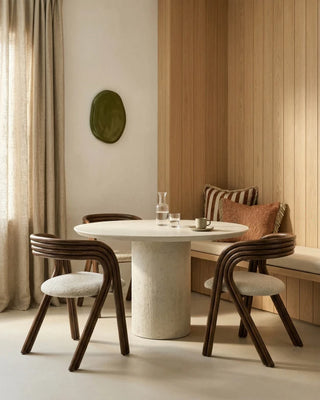 Lifestyle image of two Vincent Sheppard Arc Dining Chairs at a round white table in a dining room
