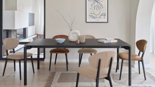 Lifestyle image of rust brown Mobitec Toro chairs at a black dining table